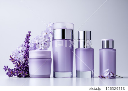 Luxurious purple-tinted cosmetic packaging set arranged with fresh lavender flowers and white blossoms on a light background. The collection includes four elegant containers a jar. Luxurious purple-tinted cosmetic packaging set arranged with fresh lavender flowers and white blossoms on a light background. The collection includes four elegant containers a jar. 126329318