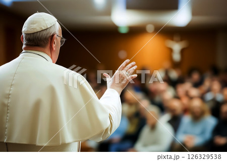 Pope addressing a large crowd from the stage. Concept Religious leader, Public speaking, Crowd engagement, Stage presence, Inspirational speech 126329538