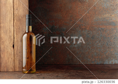 Bottle of white wine on a vintage background. 126330036