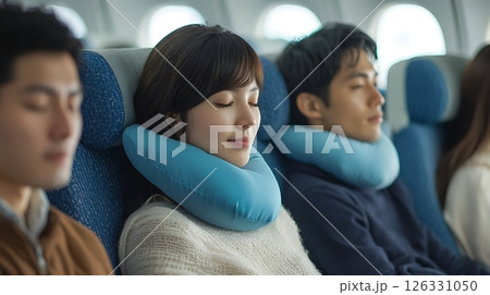 A woman is sleeping with a blue pillow on her head 126331050