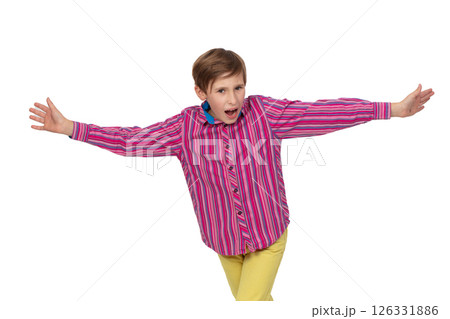 Teenage boy in striped shirt spreads arms and screams. Child on white background. 126331886