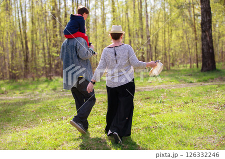 Grandfather, grandmother and grandson are having fun outdoors. 126332246
