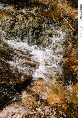 Crystal clear water flows over moss covered rocks, creating mesmerizing cascade in pristine natural setting, showcasing beauty and tranquility of untouched wilderness. Water cascading over moss rocks Crystal clear water flows over moss covered rocks, creating mesmerizing cascade in pristine natural setting, showcasing beauty and tranquility of untouched wilderness. Water cascading over moss rocks 126332606