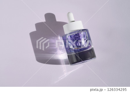 A bottle of purple face serum. 126334295