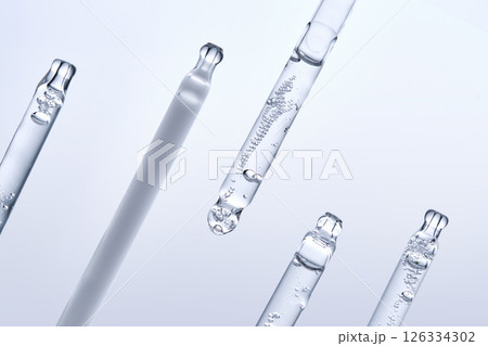 Five different droppers with facial serum in a row. 126334302