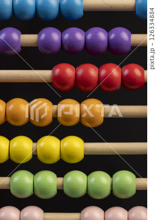 wooden children's abacus for learning and development, blue and green red and purple beads, side view wooden children's abacus for learning and development, blue and green red and purple beads, side view 126334884