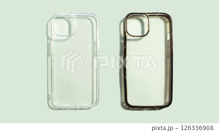 Transparent smartphone on a soft green background. One new and clean one old and dirty, showcasing before and after protective features for mobile devices. Transparent smartphone on a soft green background. One new and clean one old and dirty, showcasing before and after protective features for mobile devices. 126336908