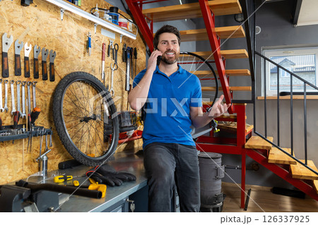 Mechanic talking on phone in workshop 126337925
