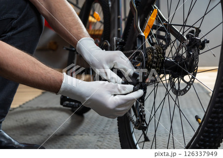 Mechanic polishing bike wheel Mechanic polishing bike wheel 126337949