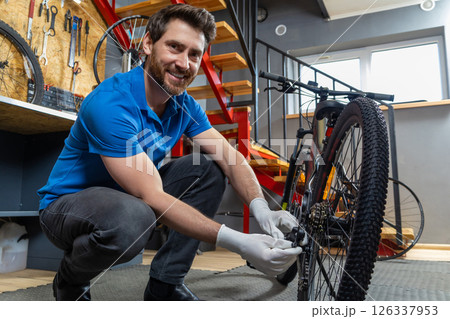 Mechanic at work with bike wheel Mechanic at work with bike wheel 126337953