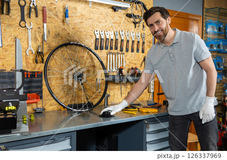 Mechanic in white gloves inspecting wheel 126337969