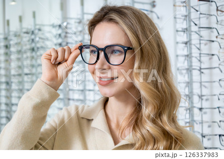 Pretty blonde caucasian woman in eyeglasses smiling nicely 126337983