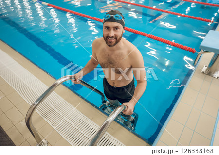 Handsome caucasian man spending time in the swimming pool Handsome caucasian man spending time in the swimming pool 126338168