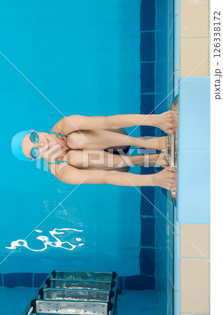 Young woman doing exercises in the swimming pool Young woman doing exercises in the swimming pool 126338172