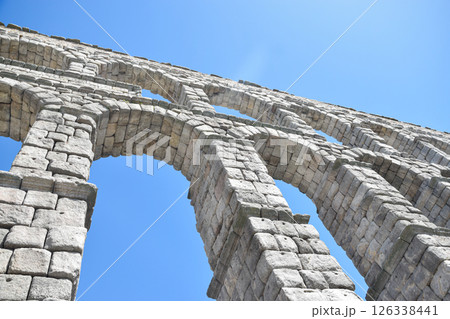Tilted bottom view of Segovia Aqueduct, Roman construction for transporting water 126338441