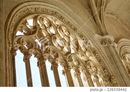 Polylabulated pointed arches inside gothic cathedral in limestone with sadows Polylabulated pointed arches inside gothic cathedral in limestone with sadows 126338442
