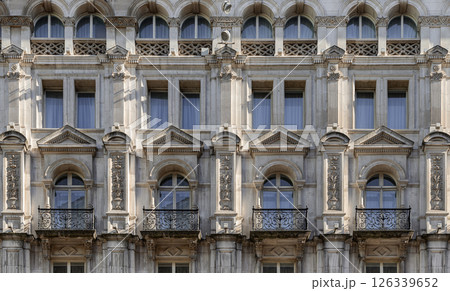 A stunning European style of Wrought iron black railings balconies and Classic glass windows in residential tenement building. 126339652