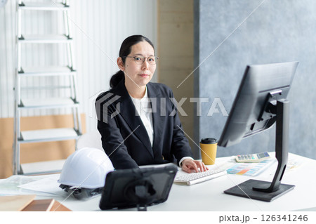 建設資料をチェックする女性社員 126341246