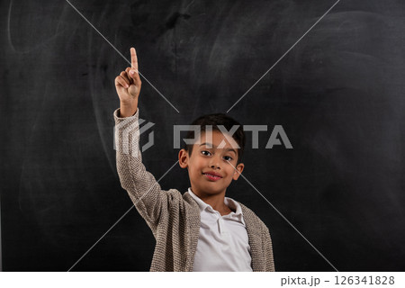 School child is raising his hands in the classroom. 126341828