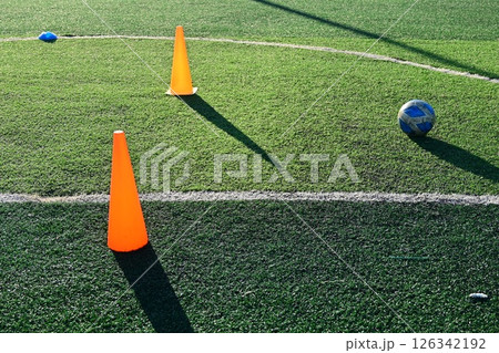 artificial green grass soccer field with orange training cones 126342192