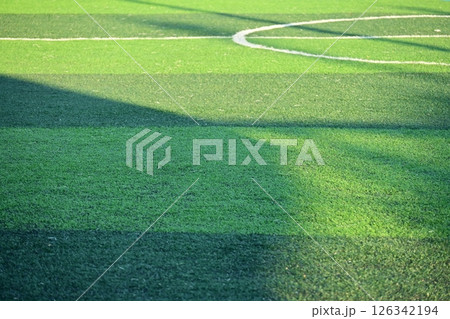 artificial green grass soccer field with sunlight, training football yard artificial green grass soccer field with sunlight, training football yard 126342194