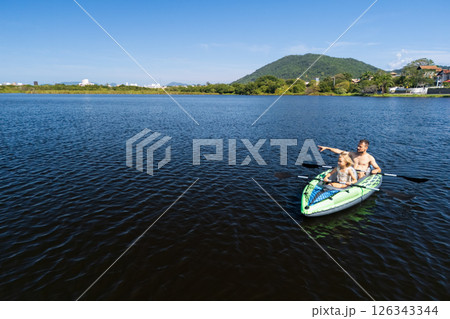 Happy active family with kids have a fun on kayak in sea lagoon.  Healthy lifestyle. Recreational water sport, outdoors activities, kayaking tour in adventure camp on family summer beach vacation 126343344