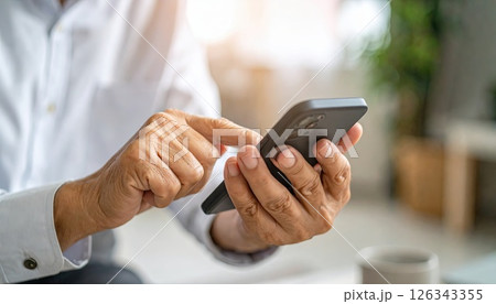 《AI画像》スマートフォンを操作する手元のクローズアップ 126343355
