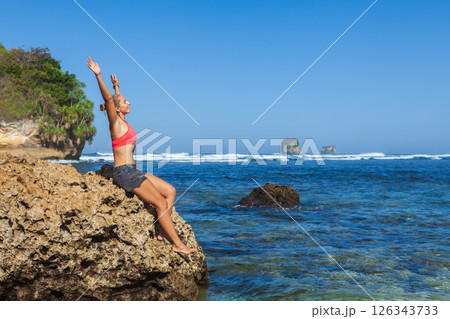 Happy young girl at amazing tropical beach with blue ocean . Active people outdoor activity on tropical summer vacations 126343733