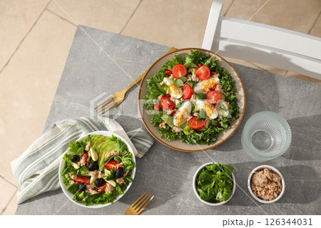 Salad with tuna on a gray table. Salad with tuna on a gray table. 126344031