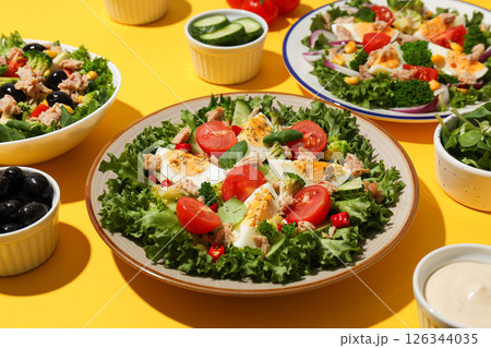 Salad with tuna on a yellow background. 126344035