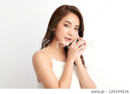 A beautiful young Asian woman with clean, fresh skin against a white background. Skincare, facial treatment, cosmetology, beauty, and spa. An elegant portrait of an Asian woman. 126344816