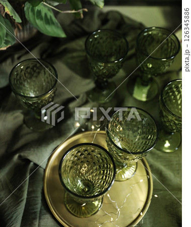 elegant green drinking set of glasses on a golden tray 126345886