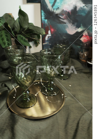 elegant green drinking set of glasses on a golden tray 126345891