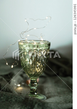 Set of elegant green drinking glasses on a golden tray 126345991
