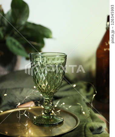 Set of elegant green drinking glasses on a golden tray 126345993