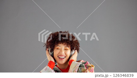 Headphones, happy and woman in studio, listening to music and singing on gray background. Person, mockup space or model with confidence, radio and headset with audio, streaming sound and song 126346839