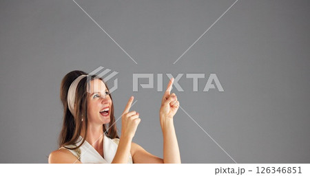 Excited, woman and pointing up to space for advertising, mockup or discount deal. Happy person, marketing and presentation in studio for retro fashion sales, promotion or offer on gray background Excited, woman and pointing up to space for advertising, mockup or discount deal. Happy person, marketing and presentation in studio for retro fashion sales, promotion or offer on gray background 126346851
