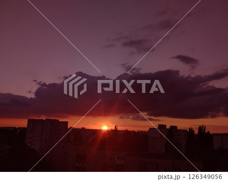 Pink order over the city with dark lilac clouds 126349056