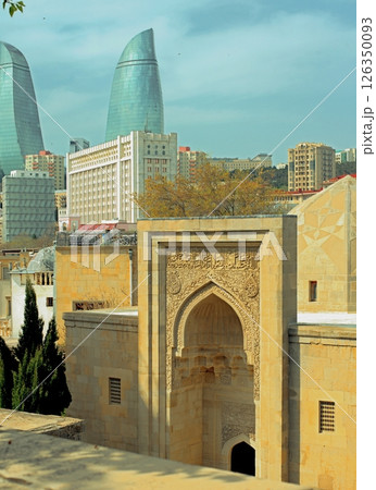 Baku city, Azerbaijan, view of historic mosques and walls of the Shirvanshahs Palace in the Old City and modern glass Flame Towers Baku city, Azerbaijan, view of historic mosques and walls of the Shirvanshahs Palace in the Old City and modern glass Flame Towers 126350093