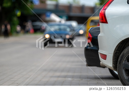 White car parked on city street. Shallow depth of feld White car parked on city street. Shallow depth of feld 126350253