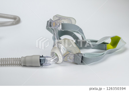 Continuous positive airway pressure- mask (CPAP) and hose isolated on white background Continuous positive airway pressure- mask (CPAP) and hose isolated on white background 126350394