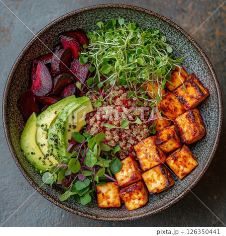 Colorful bowl of healthy ingredients featuring grilled tofu, avocado, quinoa, and microgreens Colorful bowl of healthy ingredients featuring grilled tofu, avocado, quinoa, and microgreens 126350441