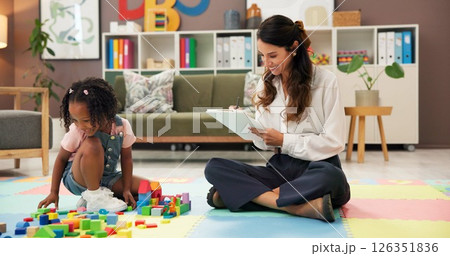 Psychology, woman and girl with clipboard, blocks and happy for evaluation, assessment or writing on floor. Person, therapist and child with toys, playful and checklist for notes with smile at clinic Psychology, woman and girl with clipboard, blocks and happy for evaluation, assessment or writing on floor. Person, therapist and child with toys, playful and checklist for notes with smile at clinic 126351836