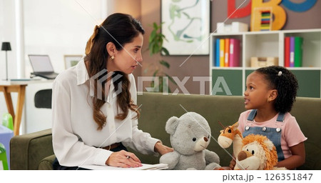 Psychologist, child and toys in office for mental health, therapy session and questions. Therapist woman, listen and girl for evaluation, clinic or consultation for patient support or development Psychologist, child and toys in office for mental health, therapy session and questions. Therapist woman, listen and girl for evaluation, clinic or consultation for patient support or development 126351847