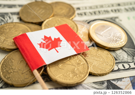Stack of coins with Canada flag and US dollar banknotes. 126352866