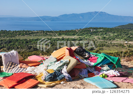 Illegally dumped household waste on scenic hillside above Aegean Sea 126354275