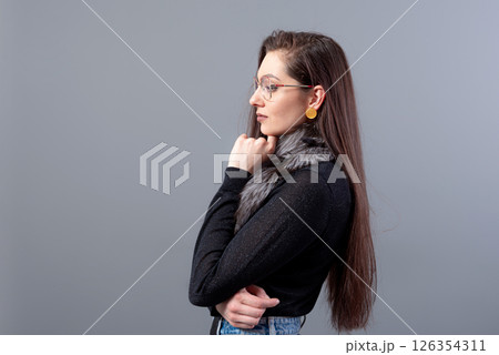 portrait of sensual woman in glasses  with long hair against gray background 126354311