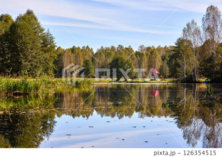 Tranquil Waterfront Gazebo on Sunny Day 126354515