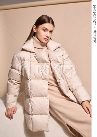 beautiful fashion female model in beige down jacket and long wool turtleneck dress in studio. Autumn winter total fashion beige look 126354644