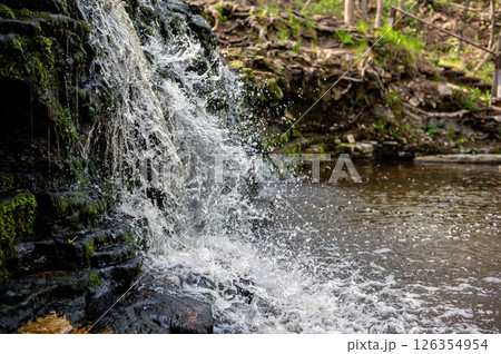 Closeup of falling and splashing streams of water, Ivande waterfall, Latvia Closeup of falling and splashing streams of water, Ivande waterfall, Latvia 126354954